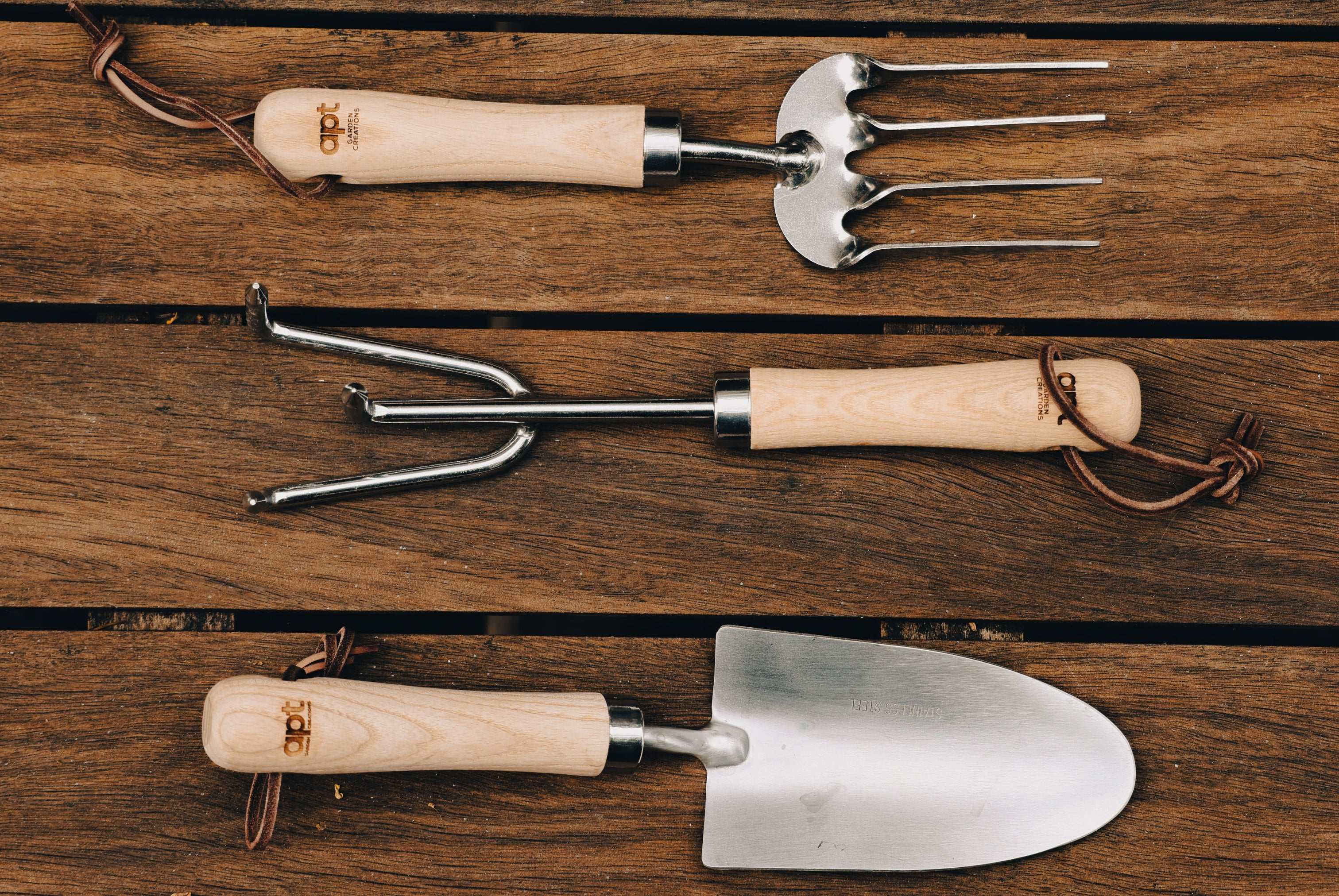 This stunning set of three garden tools, featuring ash-wood handles and stainless steel heads, a leather hang-strap and stylishly engraved with our Apt Garden Creations logo.